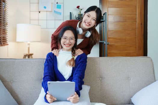 lgbtq, lgbt concept, homosexuality, portrait of two asian women enjoying together and showing love for each other while using tablet.