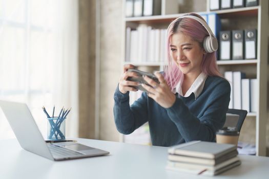 Young woman feeling excited at gaming on mobile phone, A gamer people playing video game online with smart mobile phone.