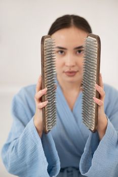 Asian woman holding sadhu boards on face background