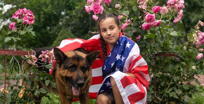 Pretty young pre-teen girl in field holding American flag. Independence Day. High quality photo