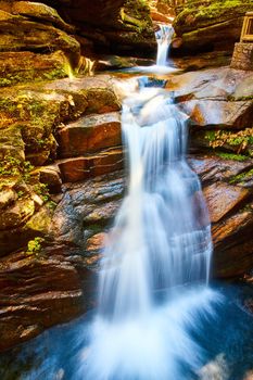 Image of Two tiers of stunning waterfalls in New Hampshire pouring through canyon up close