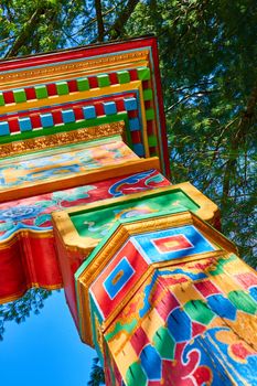 Image of Colorful posts with Tibetan Mongolian Buddhist art at gate