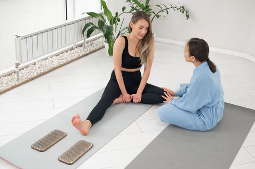 The therapist supports the client after standing on the sadhu boards. Nailing practice