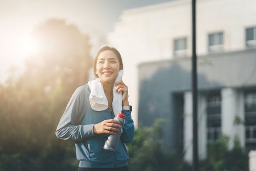 Healthy Asian woman is jogging outdoor. Fitness girl running. Female exercising at outdoor park.