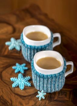 Winter holidays background with cup of hot coffee, wish list and christmas decorations