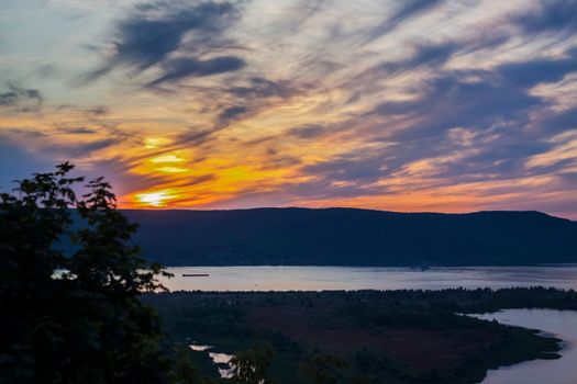 sunset on the Volga river. Natural landscape. reflection, blue sky and yellow sunlight. landscape during sunset.