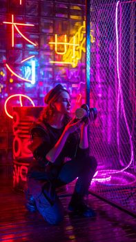Caucasian woman with a gas mask in her hands in a neon studio