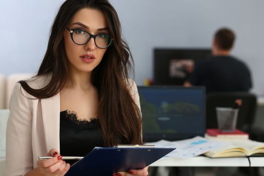 Portrait of businesswoman in beautiful glasses with documents. Business consultant or secretary concept