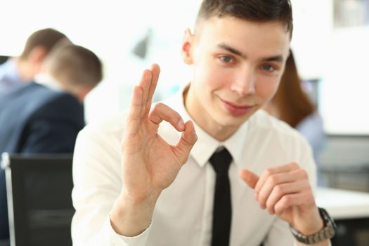 Portrait of young business male student gesturing ok on learning. Business coaching for personal growth and a successful career