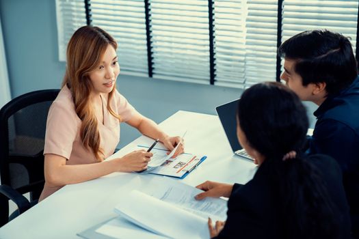 A young female asian candidate tries to impress her interviewer by being competent. International company, multicultural environment in workplace.