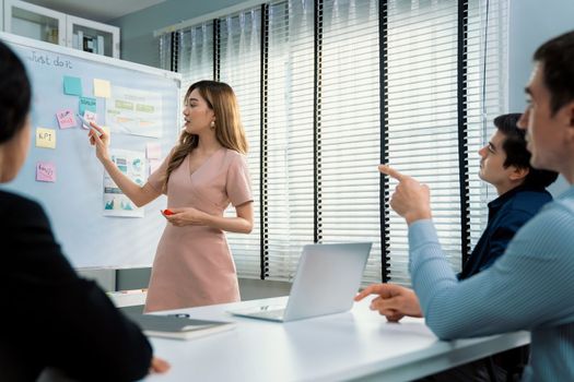 Competent office workers from various nationalities are debating, discussing and brainstorming in the meeting room. A group of employees is collaborating to achieve their business objectives.