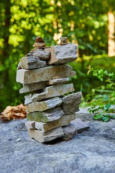 Image of Cairn stack of rectangular rocks in forest