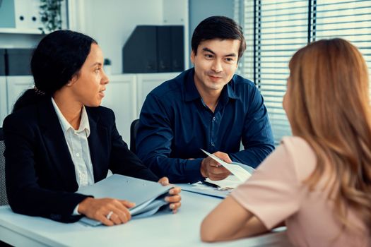 A young female asian candidate tries to impress her interviewer by being competent. International company, multicultural environment in workplace.