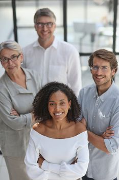 Negotiations in the office. Smiling businesswoman talks with colleagues.