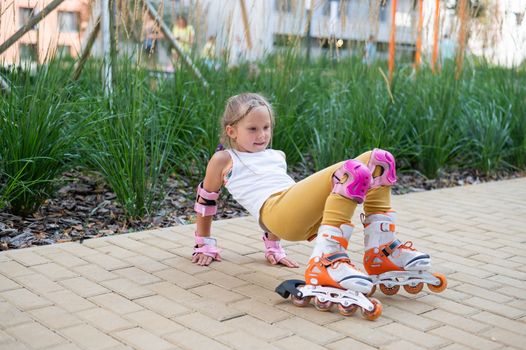 A little girl and her mom do a bridge exercise at the outdoor sports ground