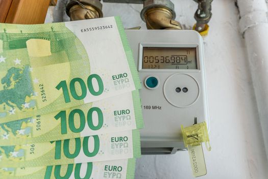 Electronic gas consumption meter with money. Close up.