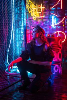 Caucasian woman posing in neon studio
