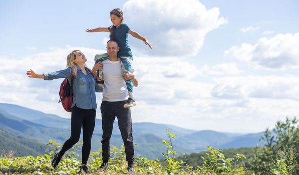 Happy family: mother, father, child daughter on nature.