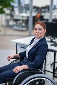 Caucasian woman wheelchair in open space office