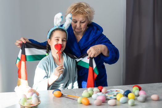 grandmother and granddaughter with uae flag for easter.