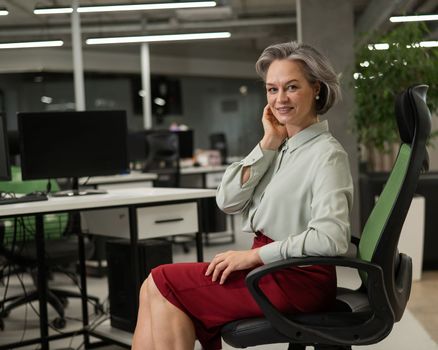 Mature caucasian woman at the desk in the office