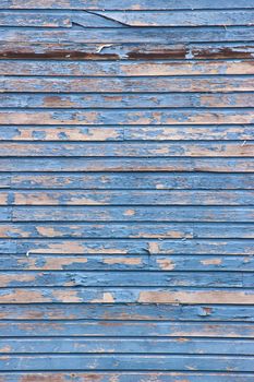 Image of Old barnwood straight on vertical texture with peeling blue paint