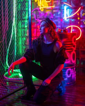 Caucasian woman posing in neon studio