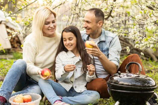 Family having a barbecue in their garden.