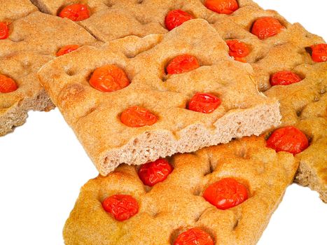 Italian flat bread organic wholewheat focaccia with tomatoes isolated in studio over a background