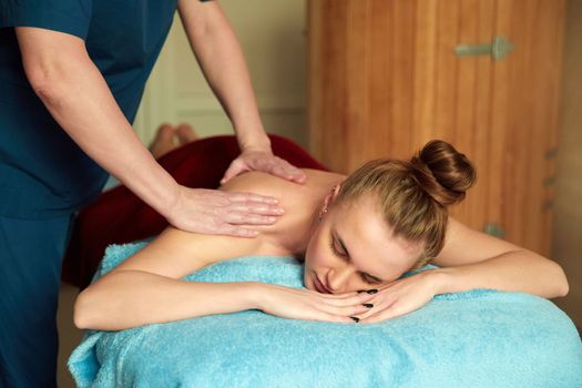 Young woman receiving massage in a spa salon