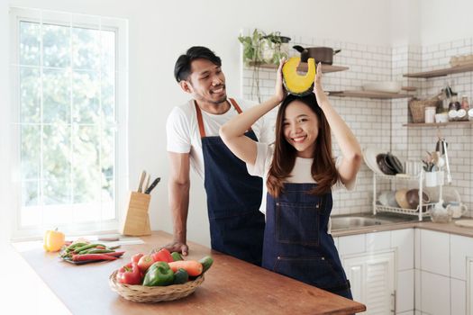 Portrait of young asian couple making salad together at home. cooking food and Lifestyle moment and healthy