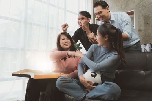 Excited friends having fun by watching football or soccer match and eating pizza at home. Friendship, leasure, rest, home party football, Soccer concept.