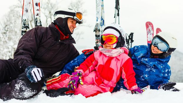 Image of sporty family spending time on winter resort during vacations