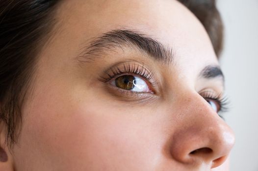 Close-up of a caucasian woman after eyelash lamination procedure