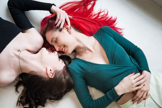 Top view of caucasian women lying and kissing