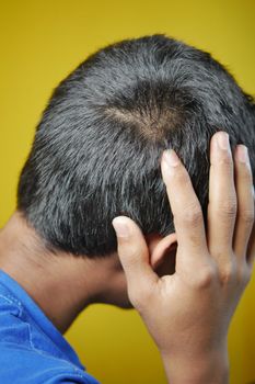 hair loss concept with man checking his hair .