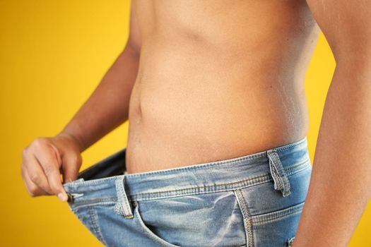 men put jeans and showing weight loss ,