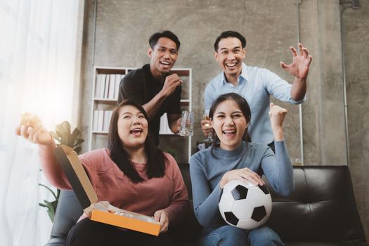 Excited friends having fun by watching football or soccer match and eating pizza at home. Friendship, leasure, rest, home party football, Soccer concept.