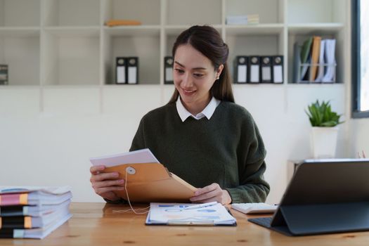 Asian Business woman making prepare presentation or important email of financial. Business Accountant working in home office