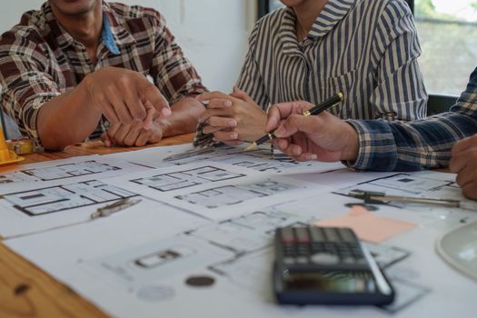 Professional architect designer structural engineer team colleagues discussing building plan design project.