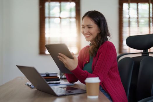 Asian Business woman working at home office and analyze financial report document. Accounting and Finance concept