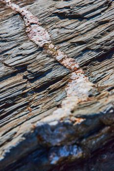 Image of Macro of mineral quartz vein going through layers of rock