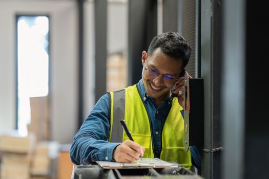 Working at warehouse. Male warehouse worker checking in storage department. Employee organizing goods distribution to the market