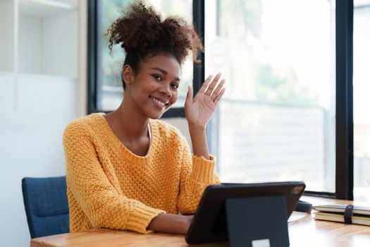 Young black curly hair american african woman using digital tablet.