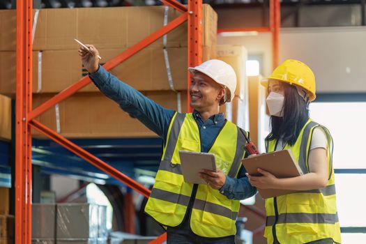 Working at warehouse. Male warehouse worker checking in storage department. Employee organizing goods distribution to the market