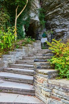 Image of Stone steps winding up into cliff wall with tunnel