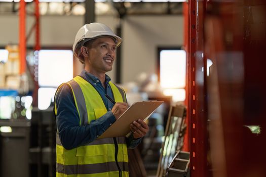 Working at warehouse. Male warehouse worker checking in storage department. Employee organizing goods distribution to the market