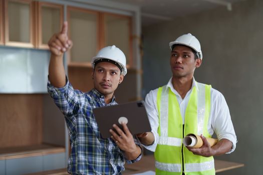 Professional architect designer structural engineer team colleagues discussing building plan design project.