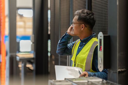 Working at warehouse. Male warehouse worker checking in storage department. Employee organizing goods distribution to the market