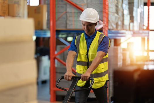 Working at warehouse. Male warehouse worker checking in storage department. Employee organizing goods distribution to the market